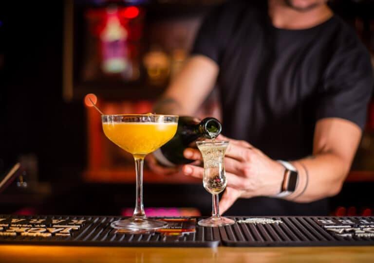 Lifestyle photo of a bartender pouring drinks