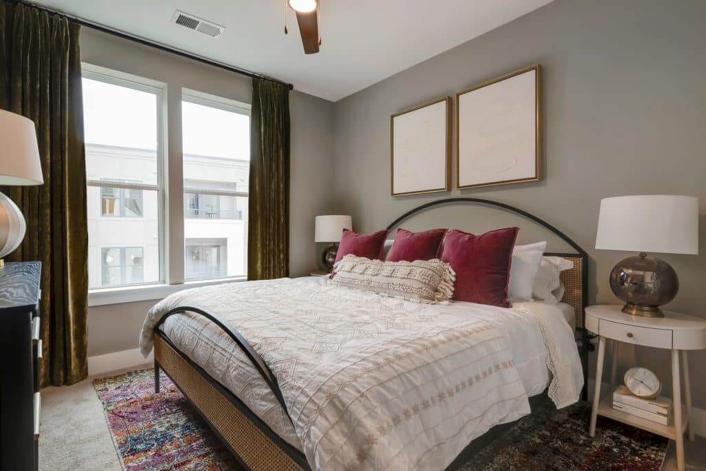 Large windows and modern furnishes in apartment bedroom at Margaux Midtown