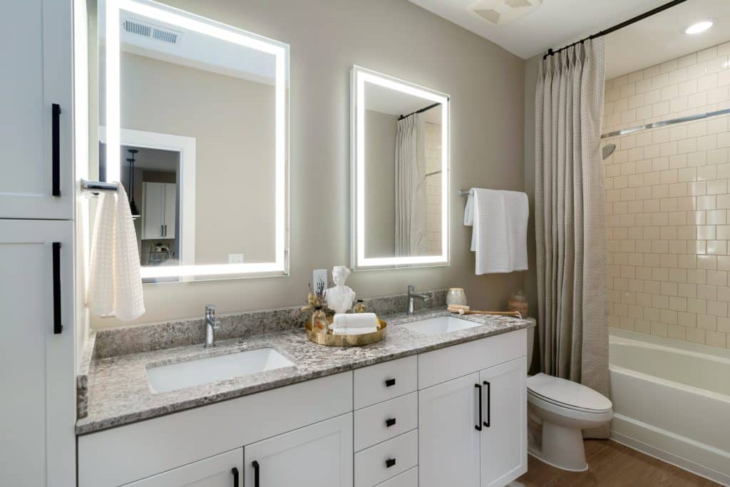 Modern apartment double vanity bathrooms with luxe finishes in each home at Margaux Midtown