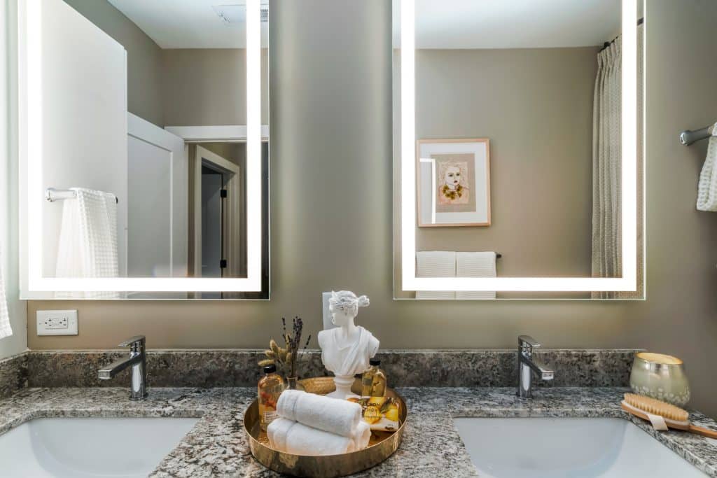 Vibrant bathroom lighting around mirrors in apartments at Margaux Midtown