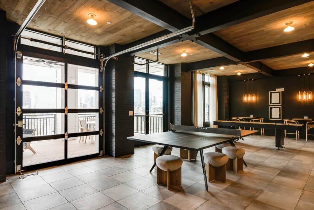 Community clubroom with ping pong and shuffleboard tables available to residents at Margaux Midtown