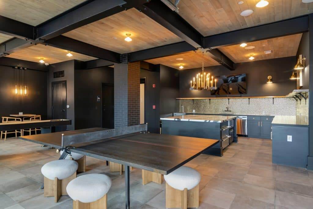 Community ping pong table and catering kitchen in Margaux Midtown's clubroom