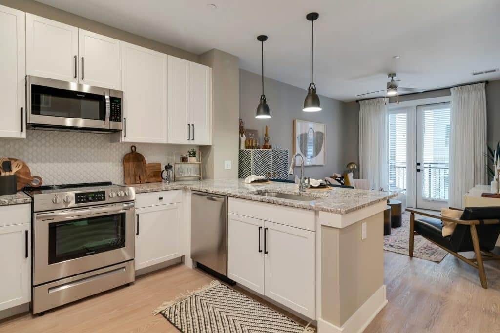 Modern lighting fixtures over kitchen bar in apartment homes at Margaux Midtown