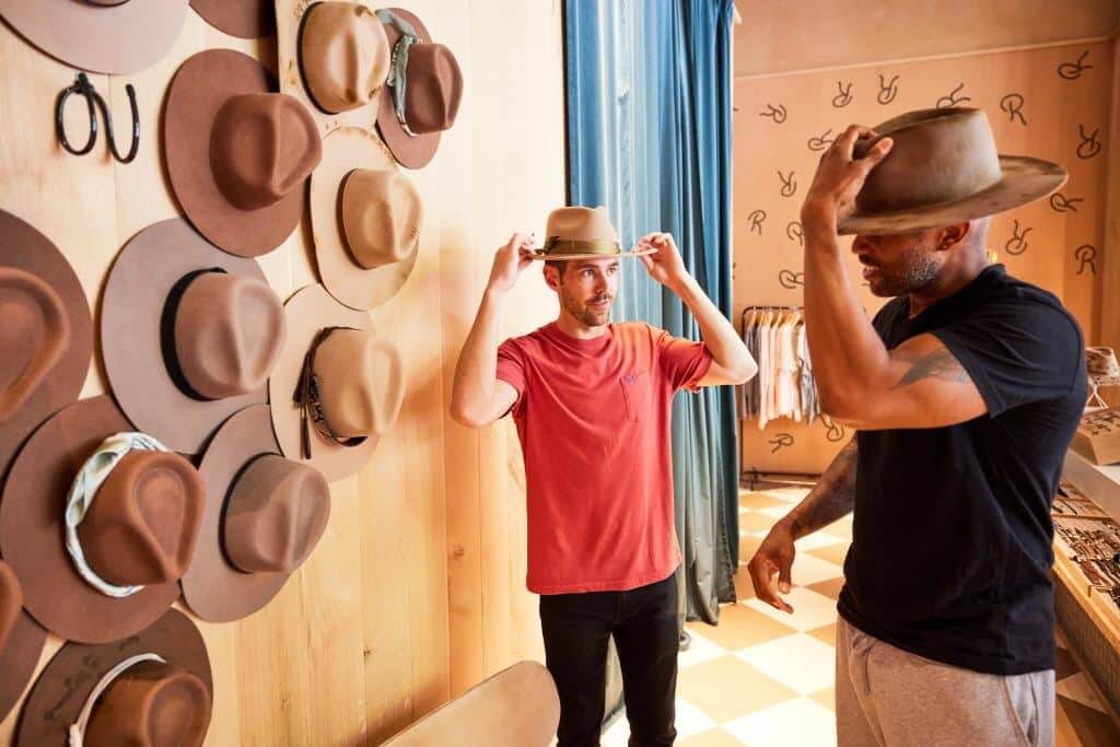 Margaux Midtown lifestyle photo of residents trying hats on