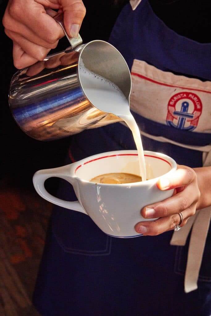 Margaux Midtown lifestyle photo of a barista making a latte