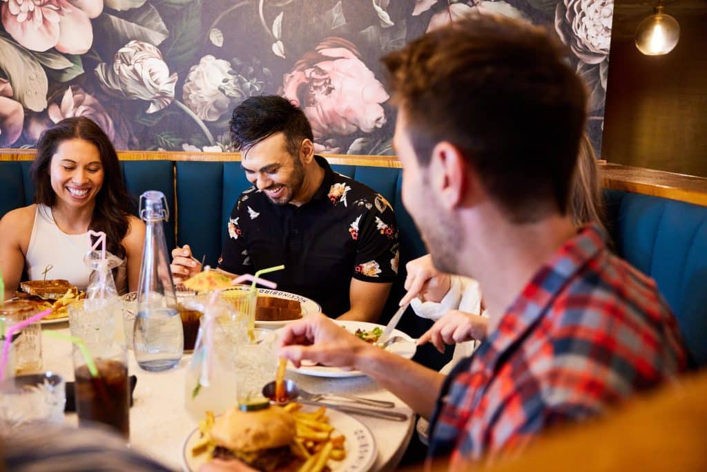 Margaux Midtown lifestyle shot of residents enjoying food