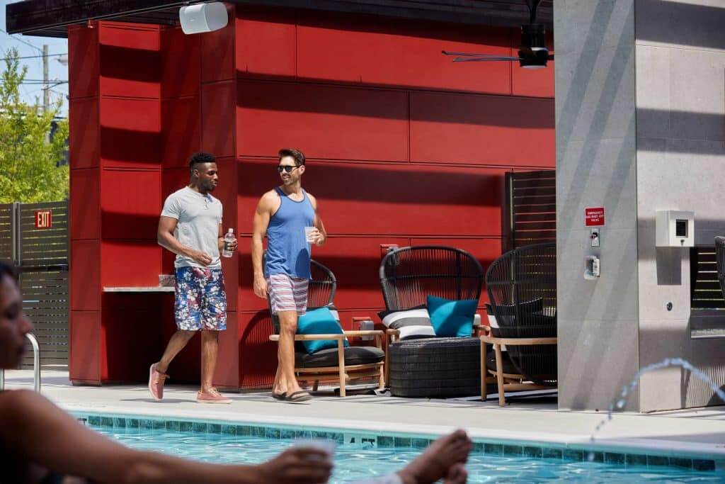 Residents walking by community pool at Margaux Midtown