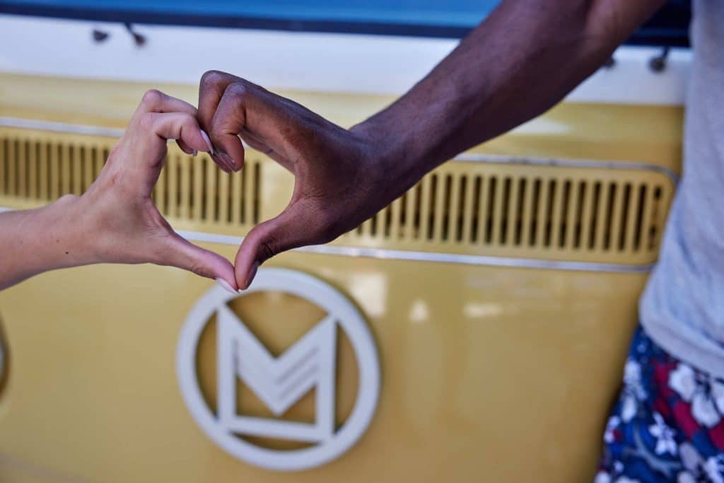 Residents at Margaux Midtown making a heart with their hands in front of property's logo