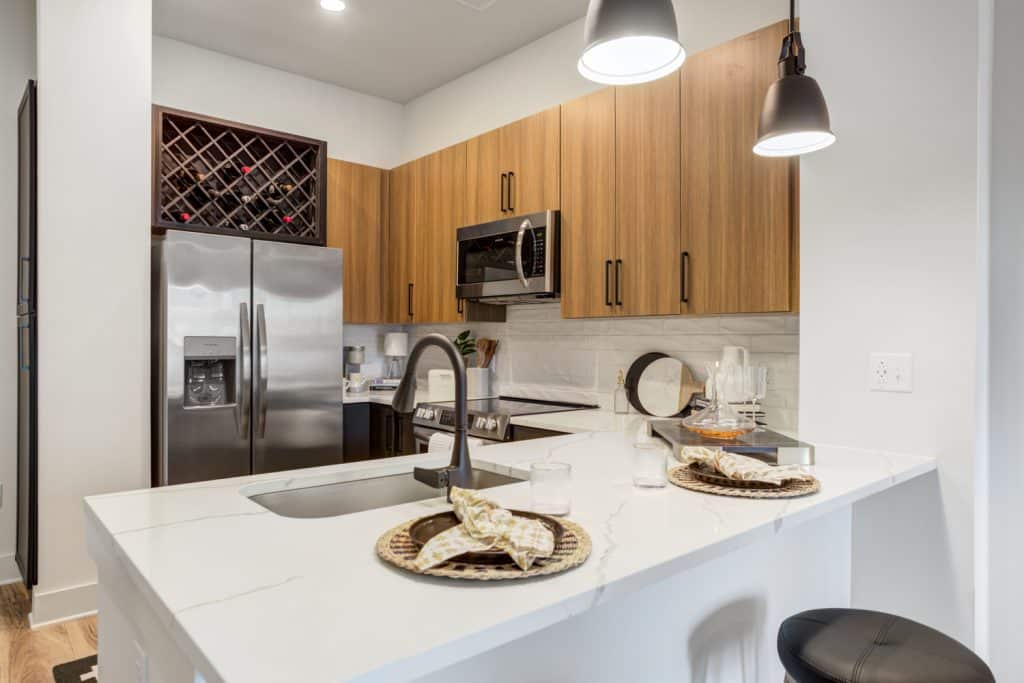 Wine storage above fridges in apartments at Margaux Midtown